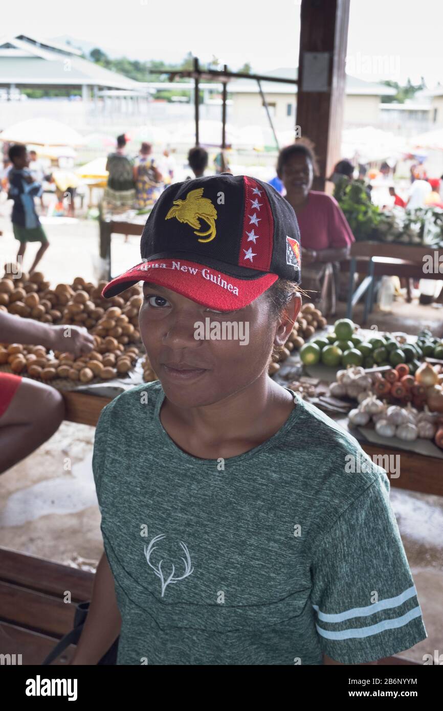 dh  ALOTAU PAPUA NEW GUINEA Native girl teenager with PNG flag cap people person locals market Stock Photo