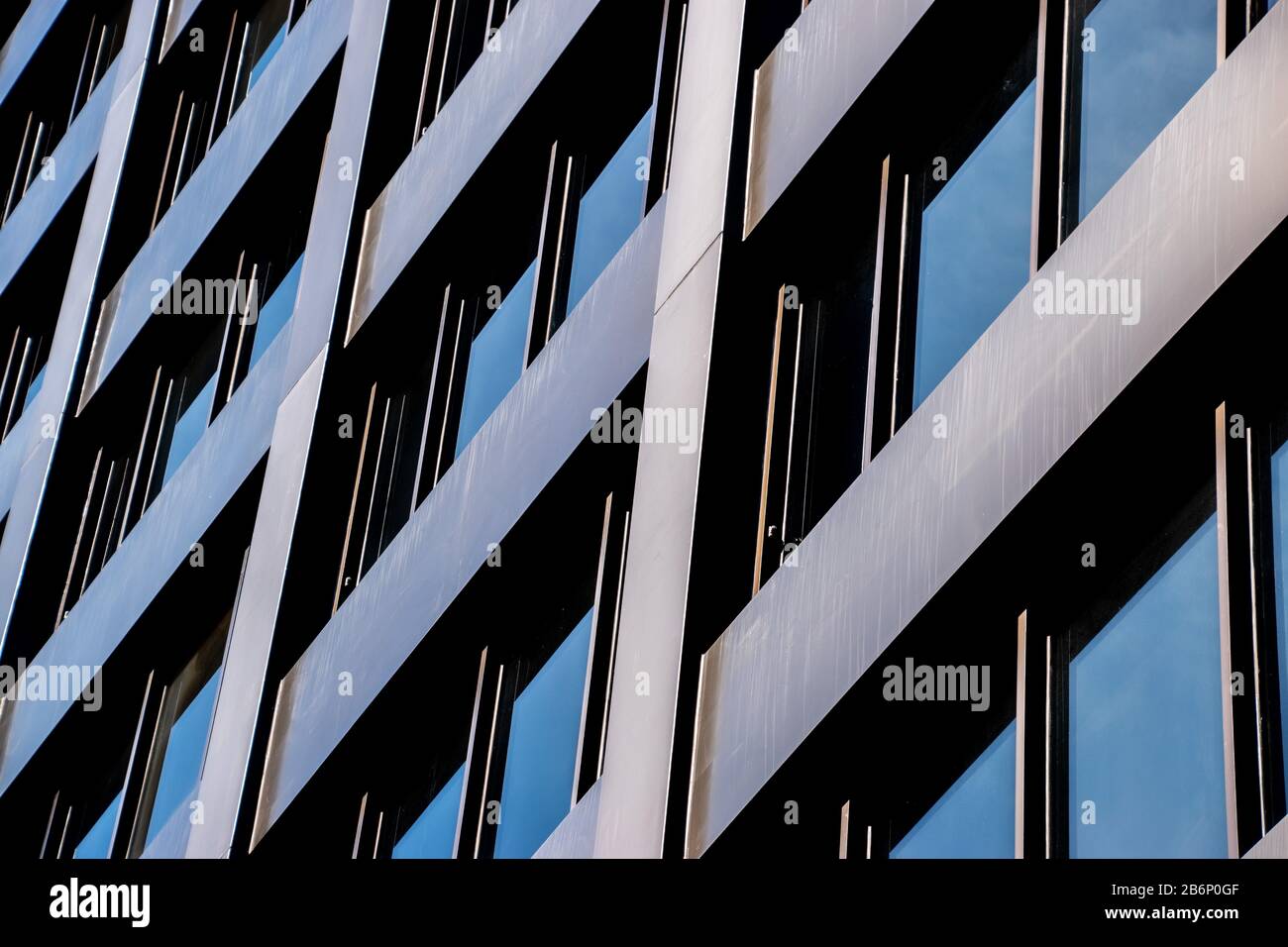 An angled view of a skyscraper with brown steel and darkened windows Stock Photo
