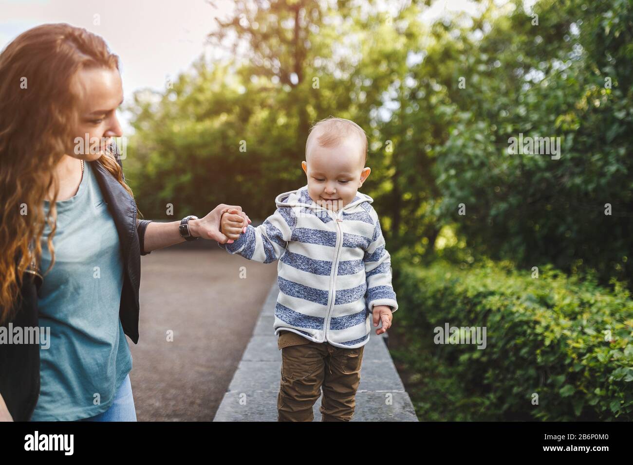 Happy Young woman with her son Walking In The Park. Stock Photo