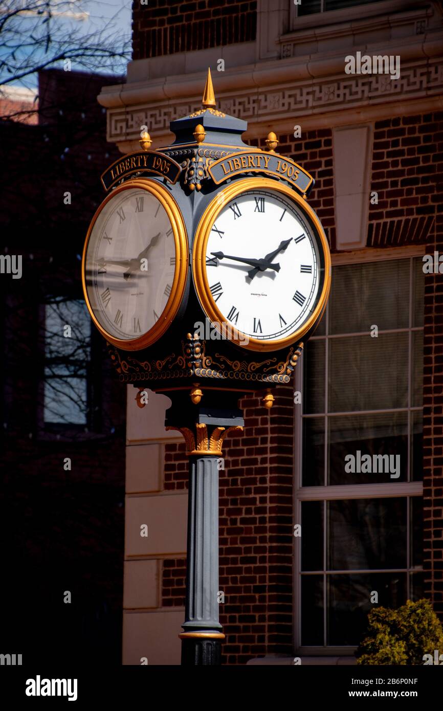 The Liberty Clock with a brick hotel in the background in downtown Greenville, South Carolina Stock Photo