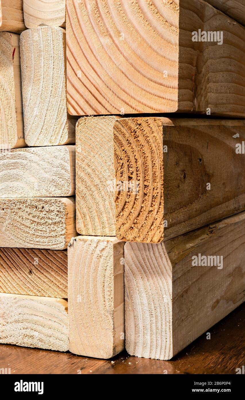 A stack of dried pine boards with a stained wood background Stock Photo
