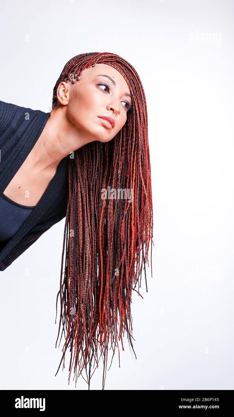 Women Hairstyle with colorful hair extensions braided in thin plaits and afrobraids Stock Photo