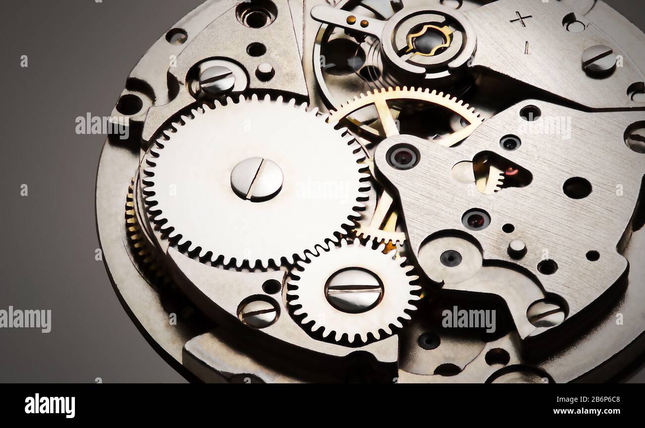 internal clock mechanism closeup view with shiny metal and gray
