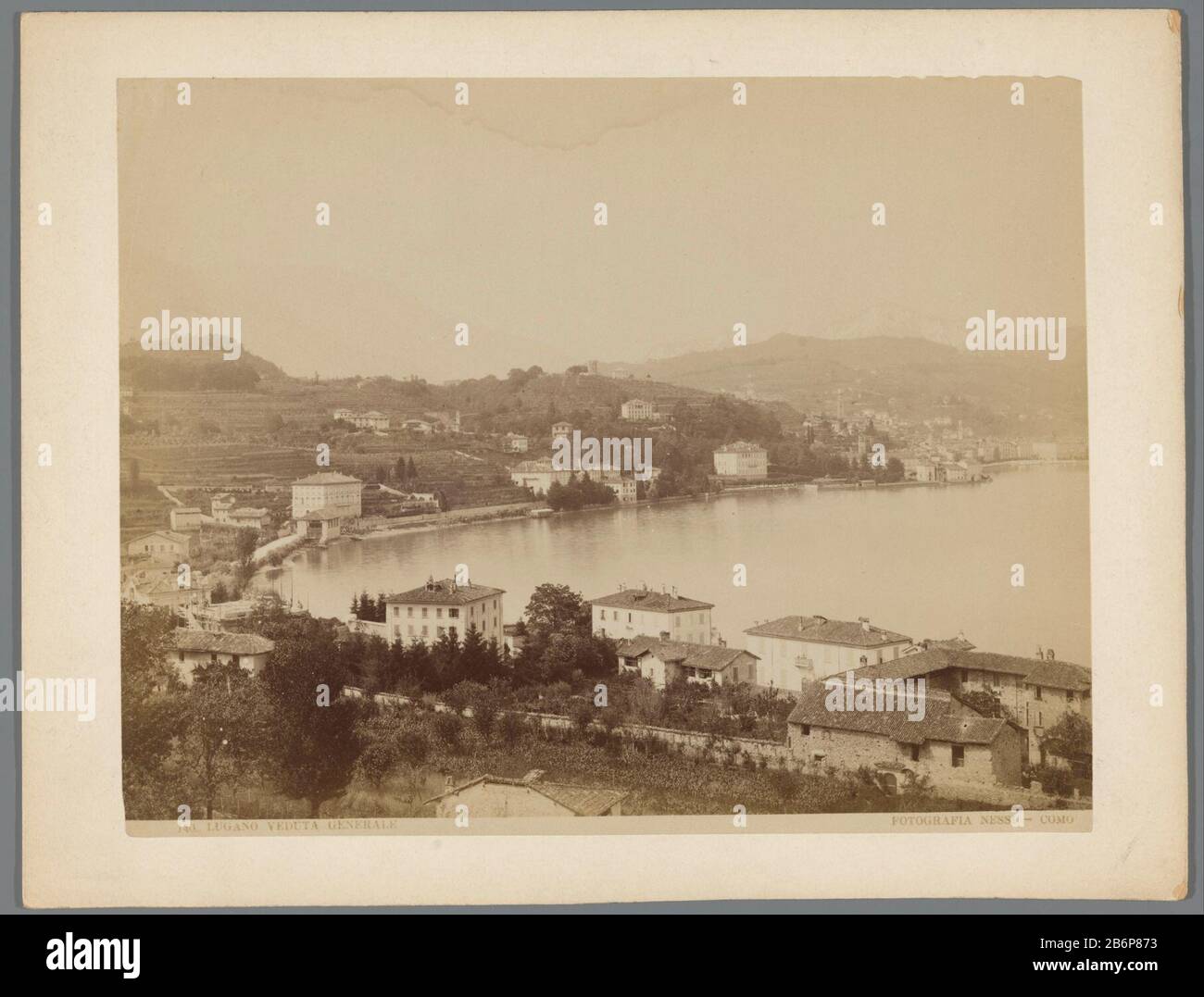 Gezicht op Lugano 140 (serietitel) Lugano veduta general manufacture manufacturer: Photographer: Antonio Nessi Dating: ca. 1860 - ca. 1880 Physical features: albumen print material: paper paper cardboard Engineering : albumen print dimensions: photo: h 212 mm × W 270 mm Subject: lake prospect of city, town panorama, silhouette of city-backs of cities and villages (Lugano) Where: LuganoD Stock Photo