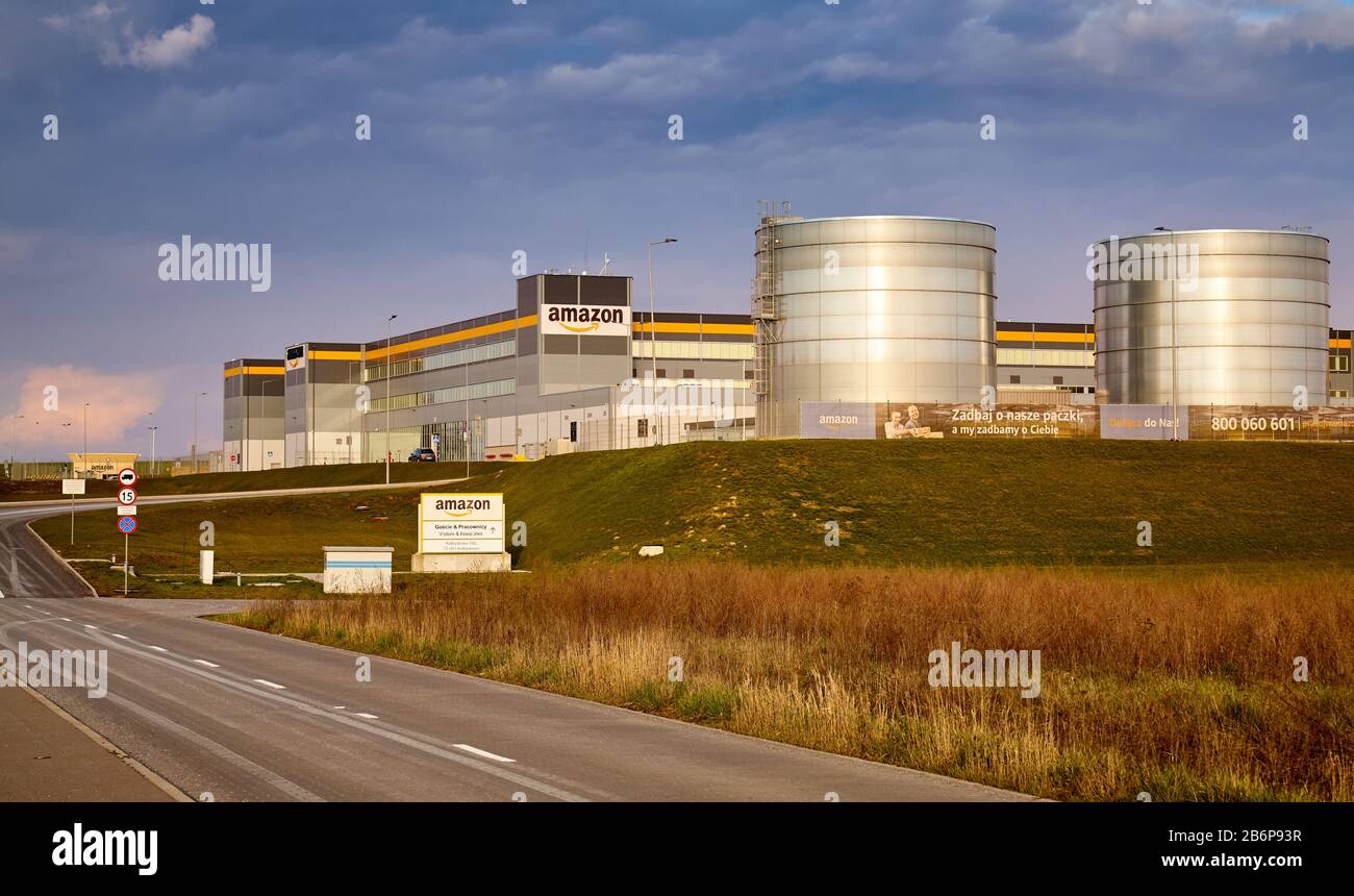 Kolbaskowo, Poland - March 05, 2020: Amazon Robotics e-commerce center with two water storage tanks at sunset. Stock Photo