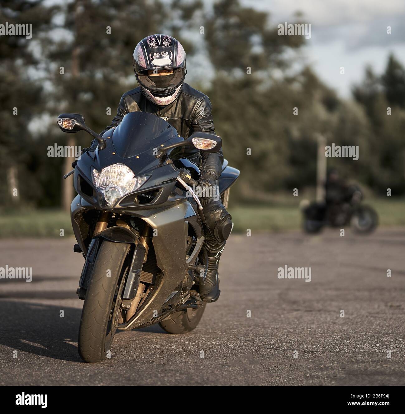 sport motorcycle. black leather jacket. Girl biker. Woman at motorcycle. Black motorcycle. Motorcycle rider Stock Photo
