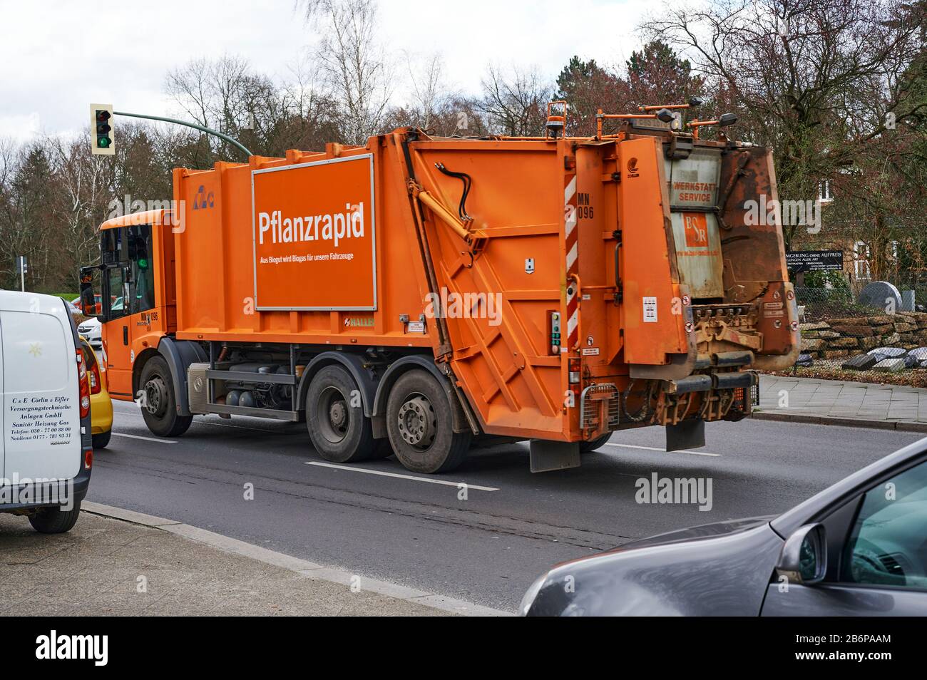 Berlin, Germany - March 11, 2020: Street scene with a truck of the Berlin city cleaning. On the side of the truck you see a sign that humorously adver Stock Photo