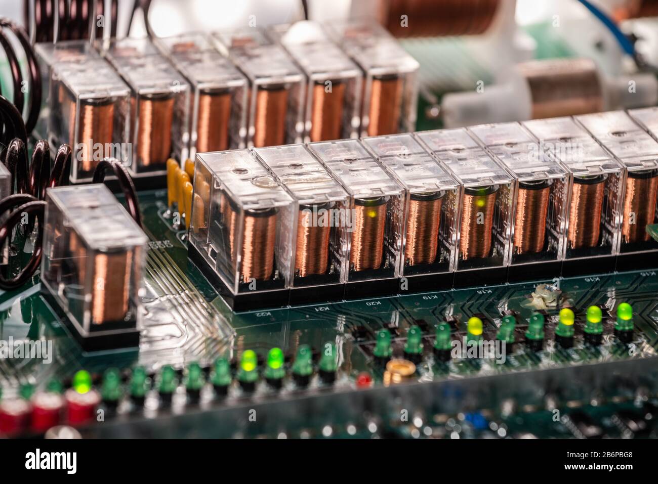 Closeup of a coil with copper wire is connected to a large green