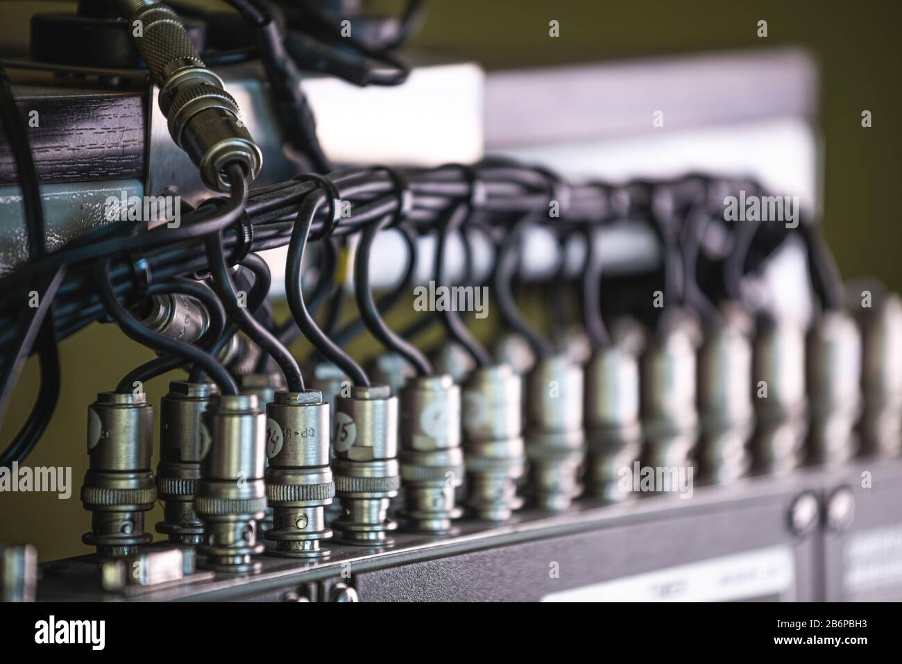 Close-up side view of a wire and a numbered plugs connected to each ...
