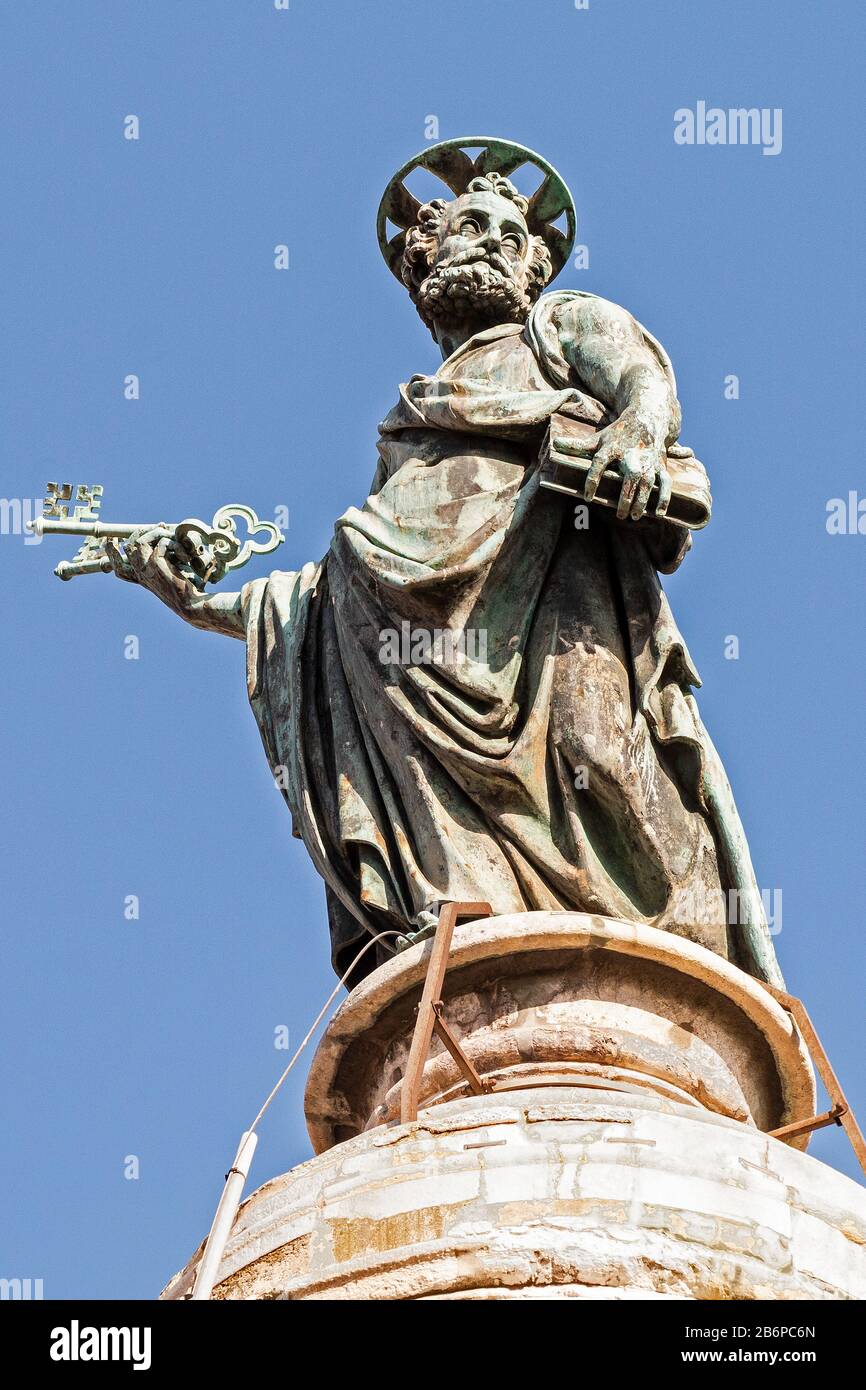 St Peter carrying the the Keys to Heaven. Medieval bronze  sculpture cost by pope Sixtus V on top of the ancient Trajan's Column in Rome, Italy Stock Photo