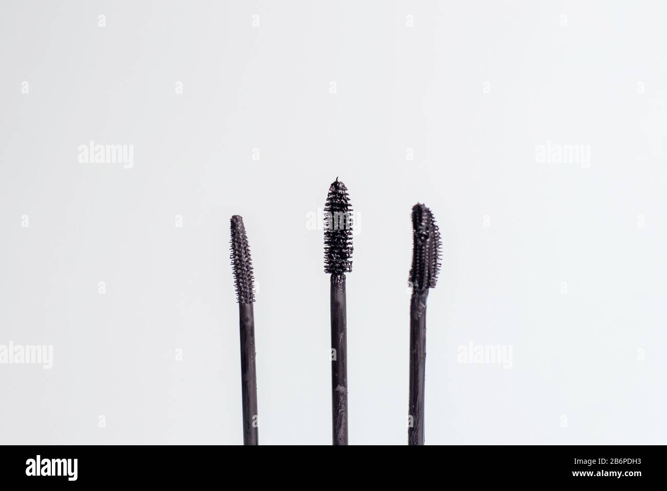 Three different mascara brushes. Various mascara brushes on a blue