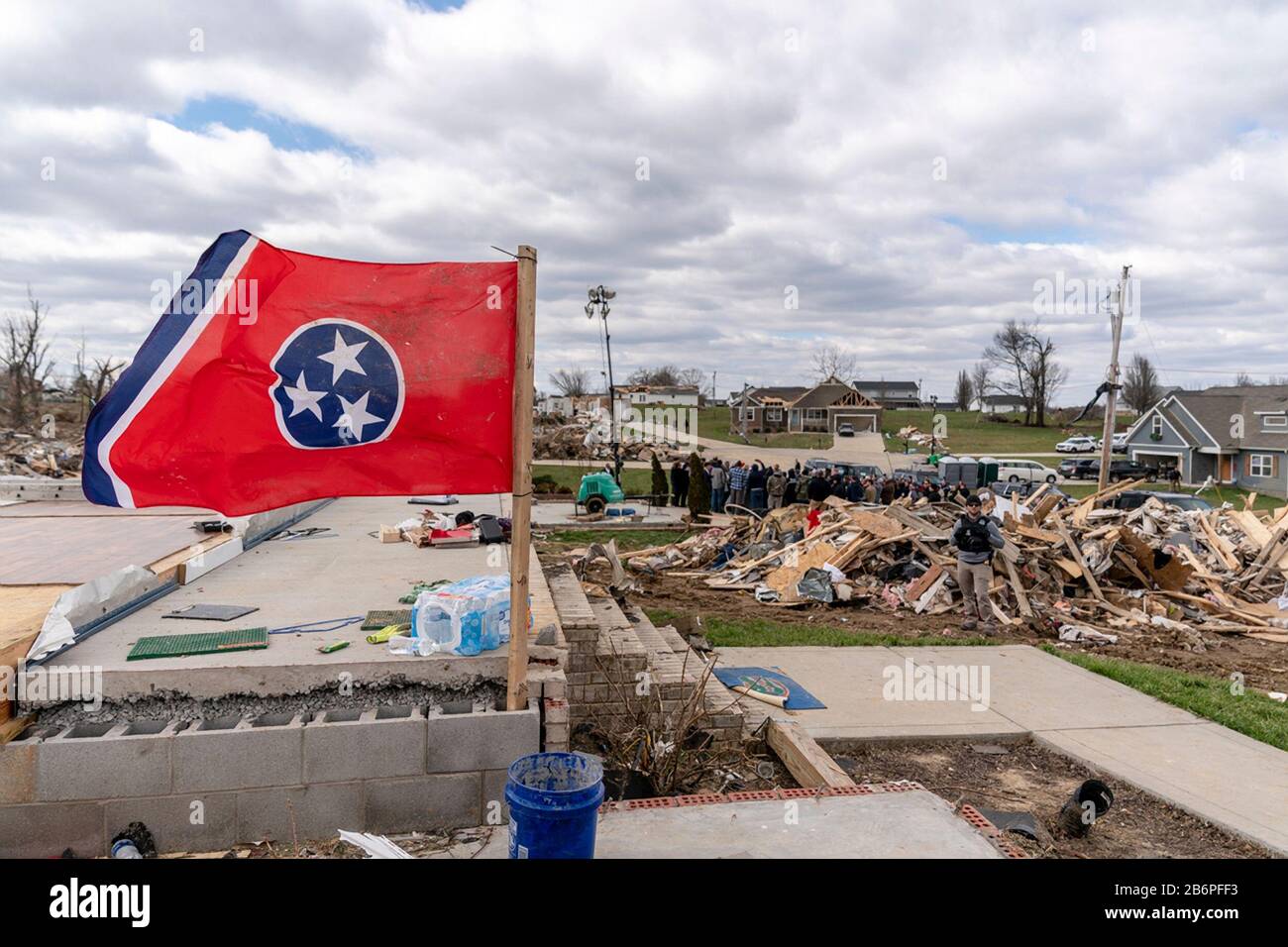 The Tennessee state flag flies over destroyed homes in the aftermath of a massive tornado March 6, 2020 in Cookeville, Tennessee. U.S President Donald Trump visited Nashville and the surrounding area to survey tornado damage that killed more than 24 people. Stock Photo