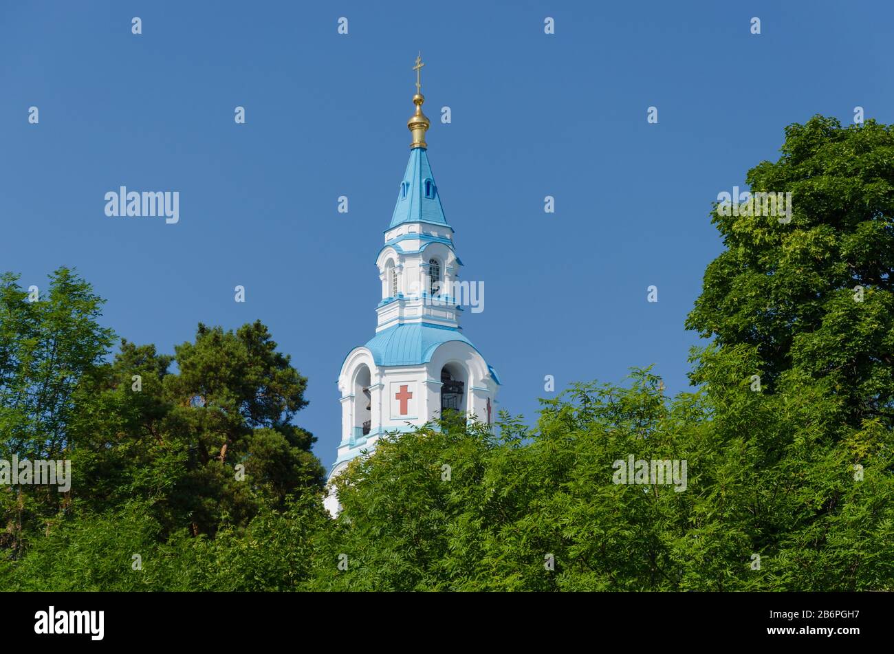 View of the bell tower of the Orthodox Cathedral framed by greenery.Spaso-Preobrazhensky Cathedral of the Valaam Monastery. Stock Photo