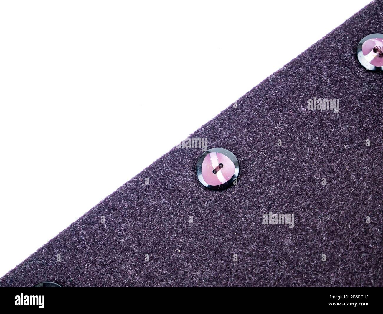 Colored button on a woolen cloth coat. Stock Photo