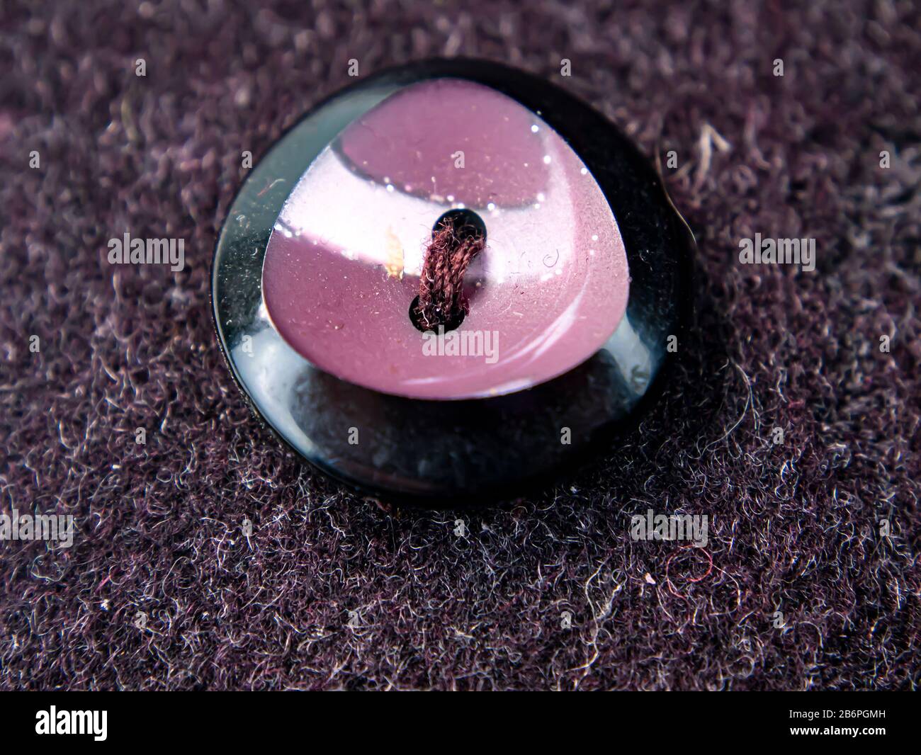 Colored button on a woolen cloth coat. Stock Photo