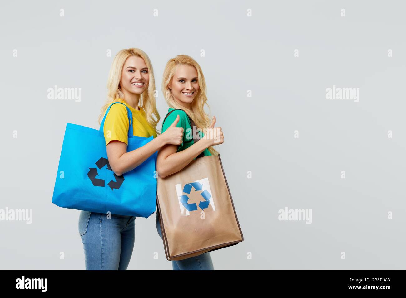 Ecology Concept. Young women in casual clothes are holding ecological ...