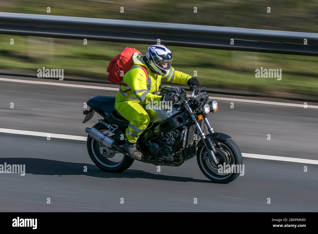 kawasaki motorbike and rider riding on the M6 motorway near Preston in Lancashire, UK Stock Photo