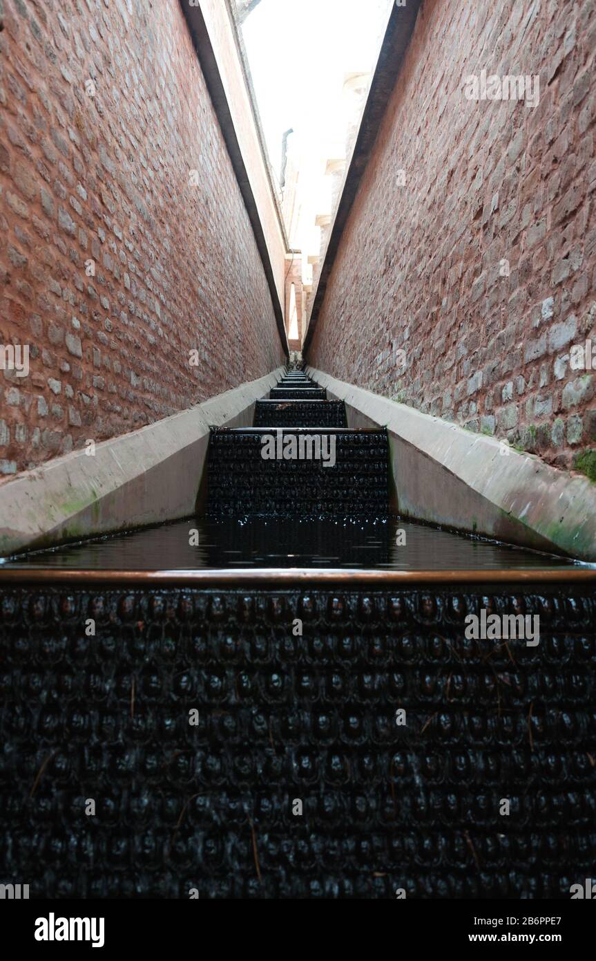 Still waterfall within brick walls Stock Photo Alamy