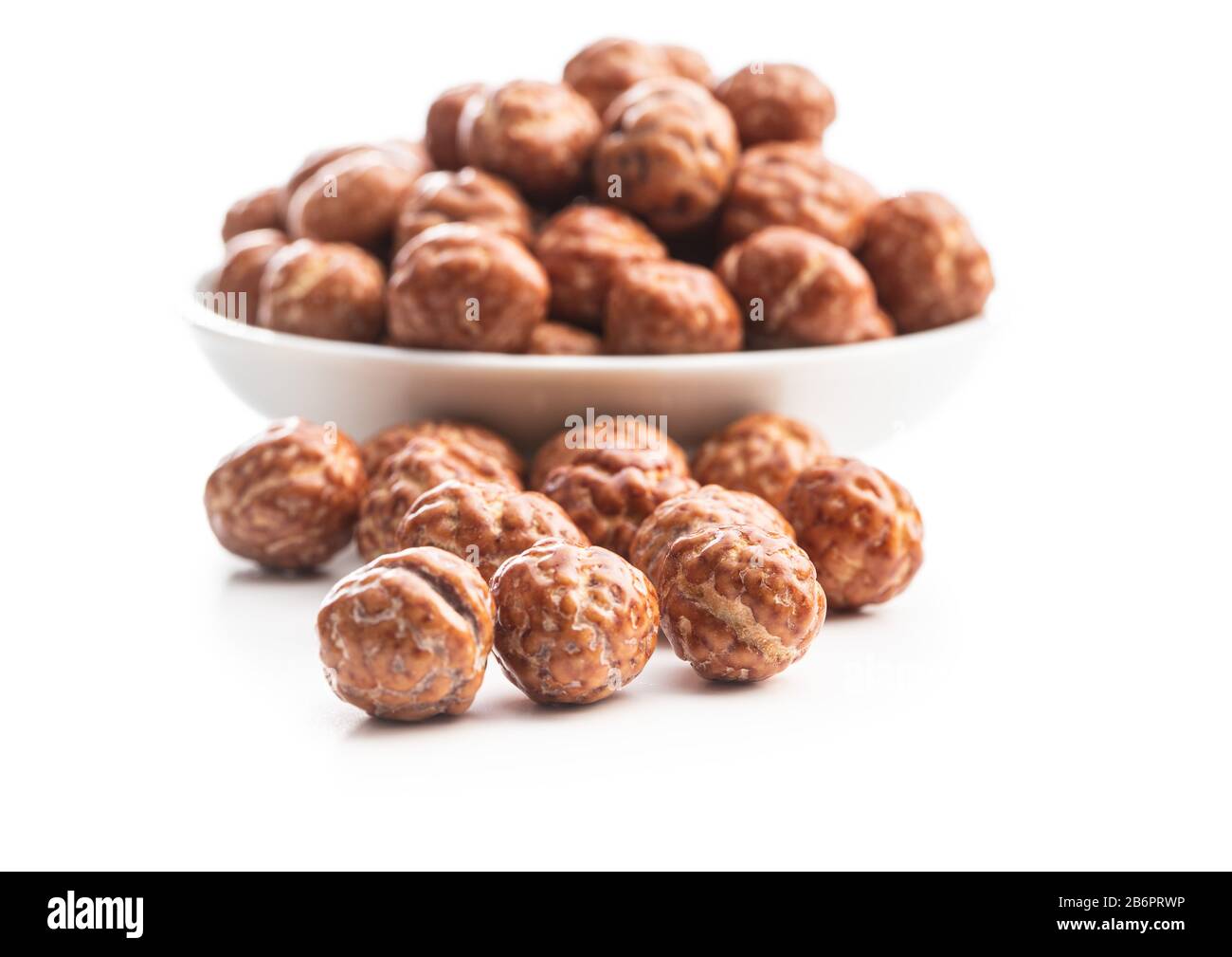 Hazelnuts with sugar icing isolated on white background. Stock Photo