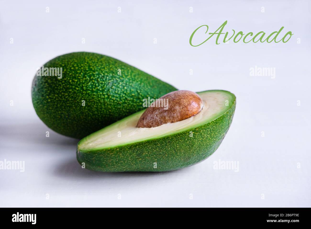 Avocado fruit close-up. Sliced avocado on a light background. Stock Photo