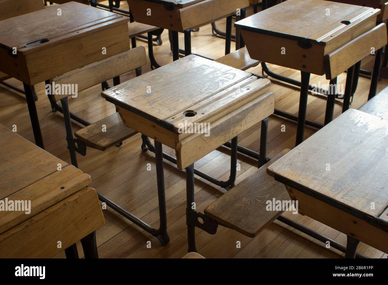 Rows Of Old Fashioned School Desks In A Classroom In Day Light