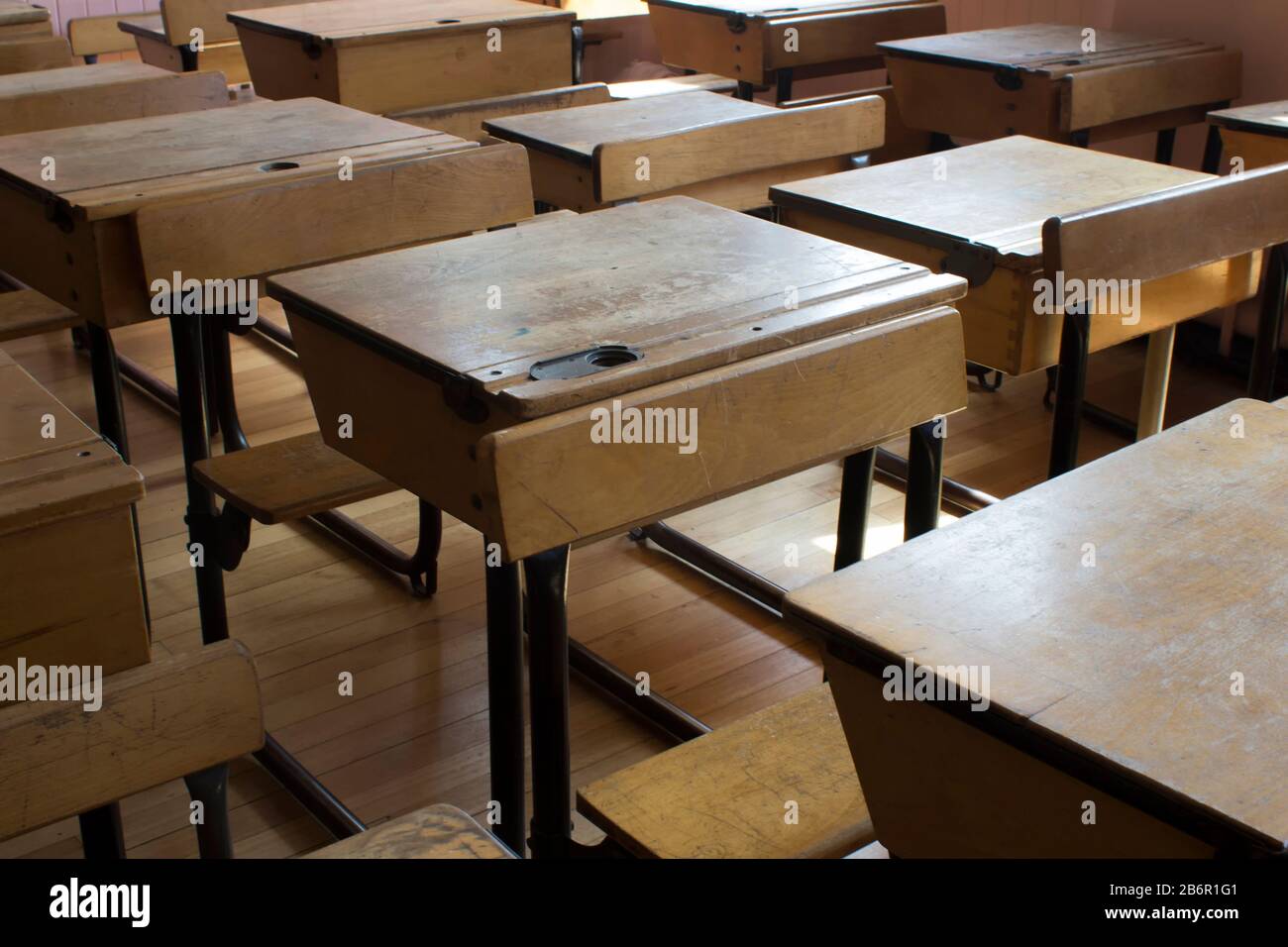 Rows Of Old Fashioned School Desks In A Classroom In Day Light