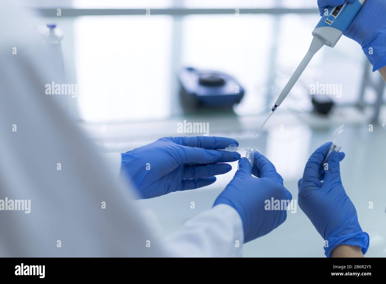 Group of Microbiologists with a tube of biological sample contaminated ...