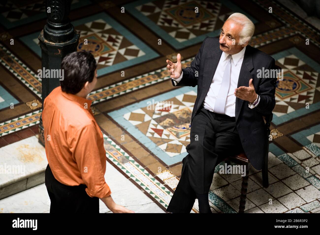 Side view of two men engrossed in a discussion. Stock Photo
