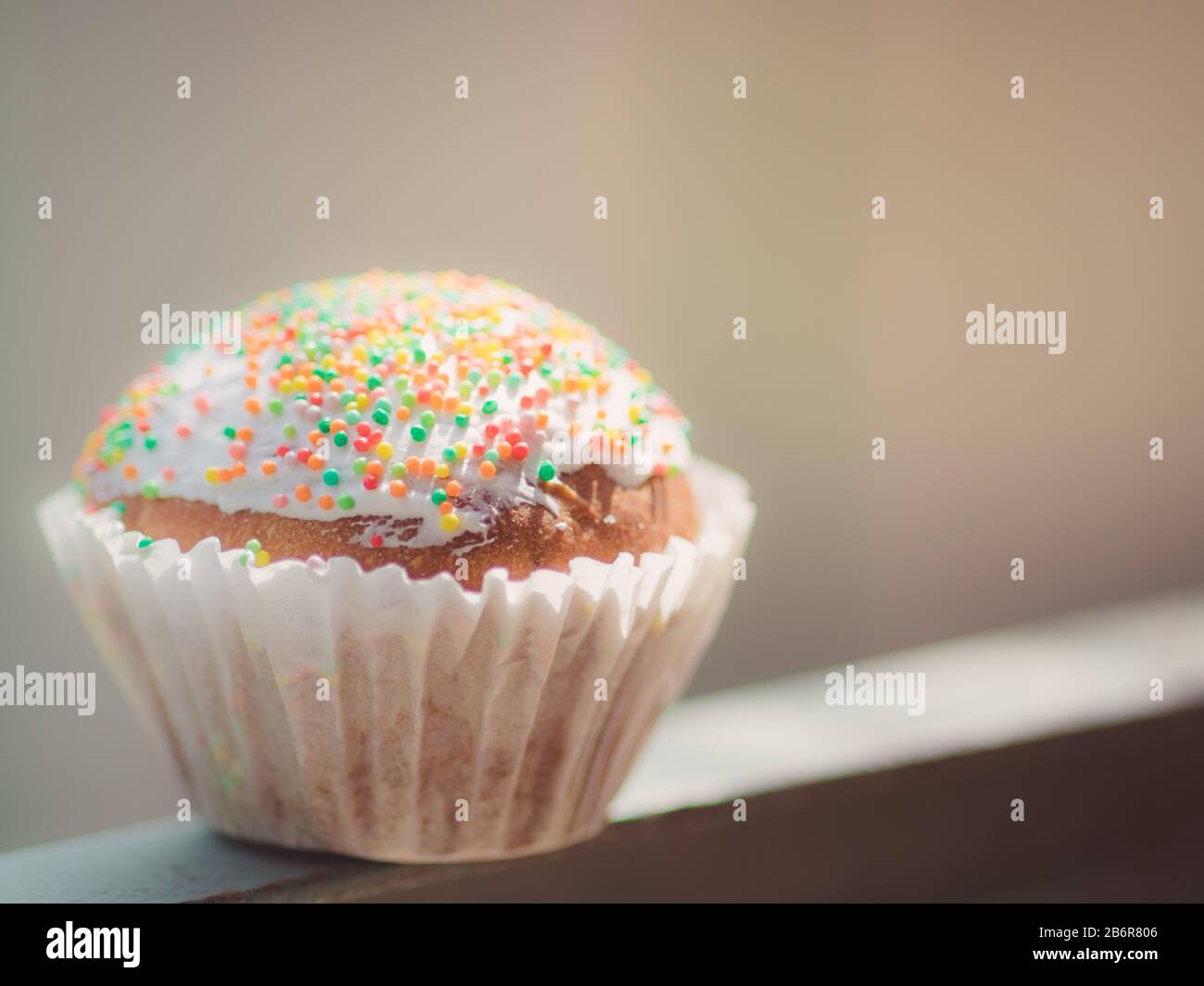 small easter cupcake wrapped in white paper. Stock Photo