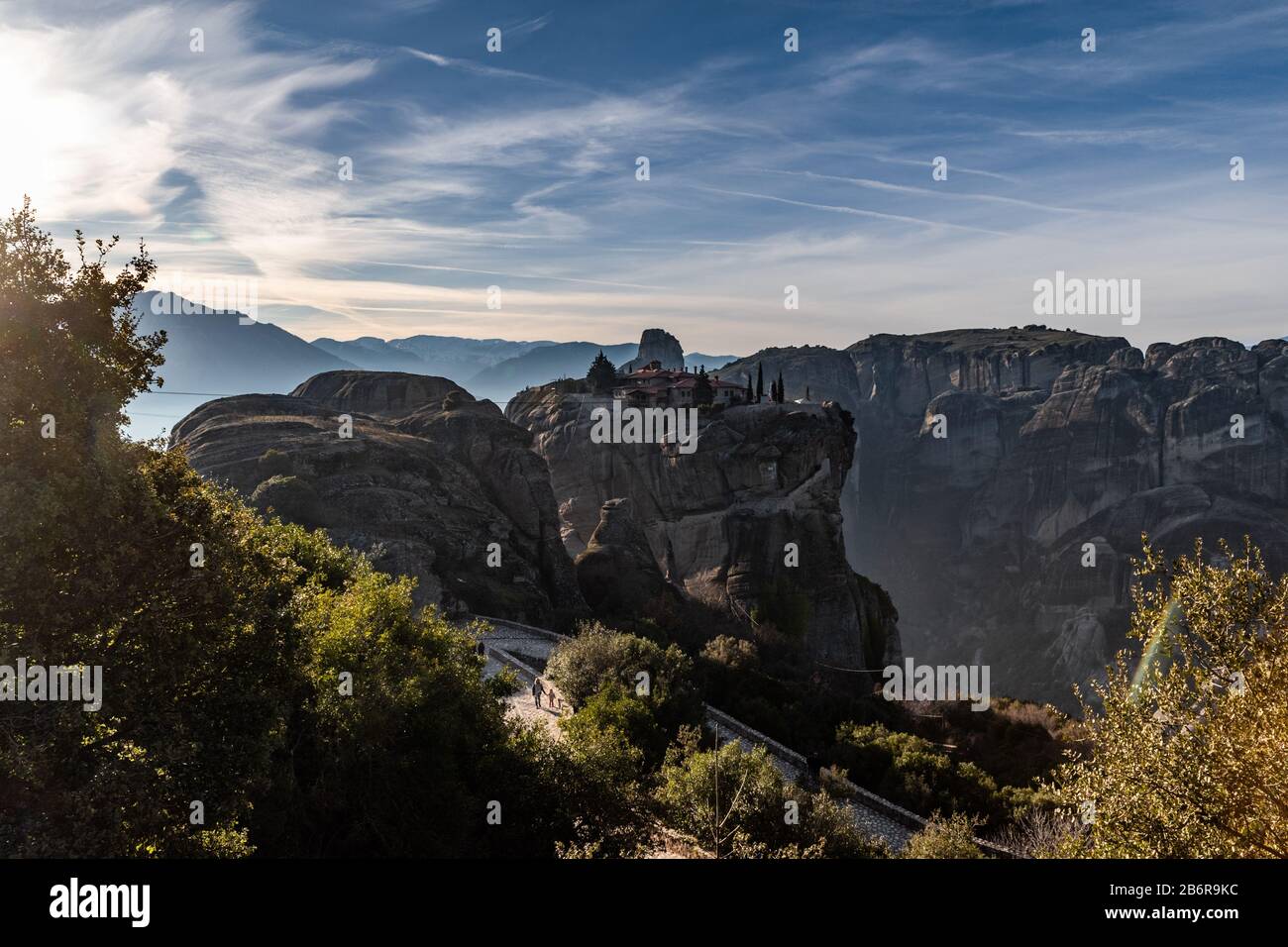 Aerial view of monastery Trinity and breathtaking pictures of valley and landmark canyon of Meteora at sunset, Kalambaka, Greece, shadows, twisted roa Stock Photo