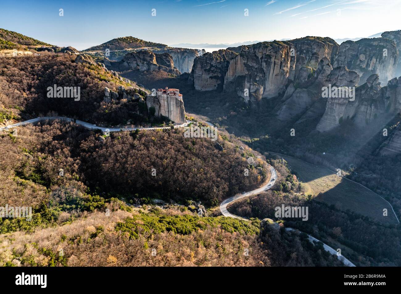 Aerial view of monastery Rousanou and breathtaking picturesque valley and landmark canyon of Meteora at sunset, Kalambaka, Greece, shadows, twisted ro Stock Photo