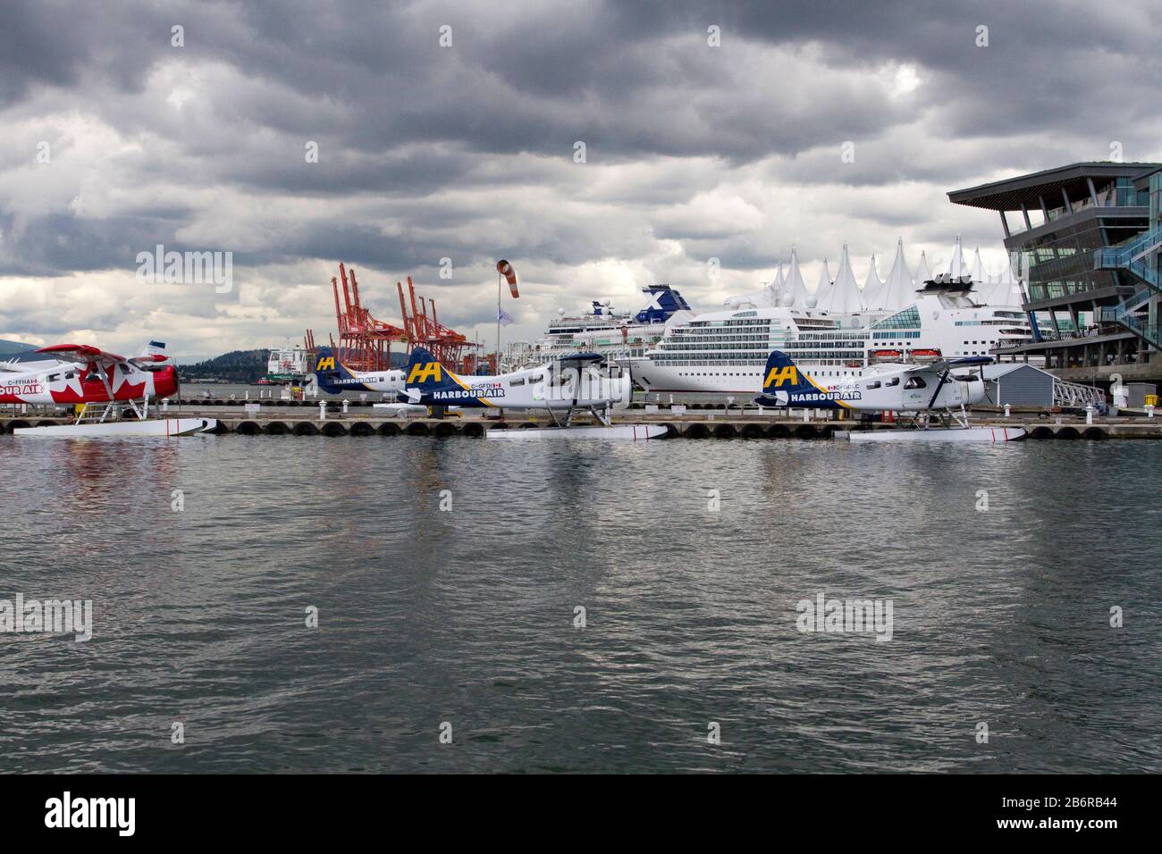 2 Harbour Air DHC-3 de Havilland Turbine Single Otter seaplanes at Coal Harbour, Vancouver, BC, Canada with gantry cranes & Canada Place in background Stock Photo