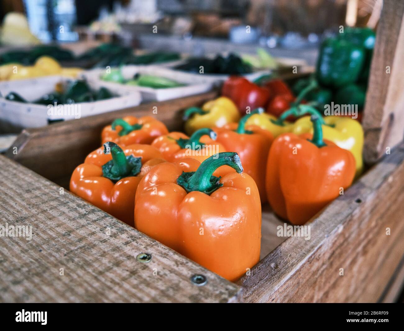 Fresh orange peppers on the shelf at a farm or farmers market or roadside fresh vegetable stand in Pike Road Alabama USA. Stock Photo