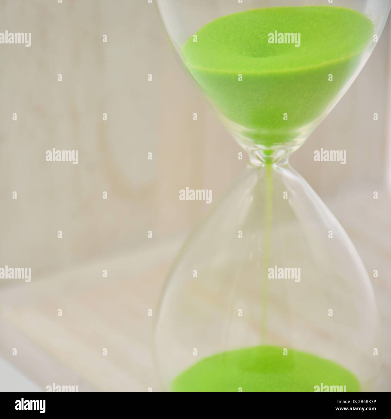 Hourglass, with green sand, arranged in different ways Stock Photo
