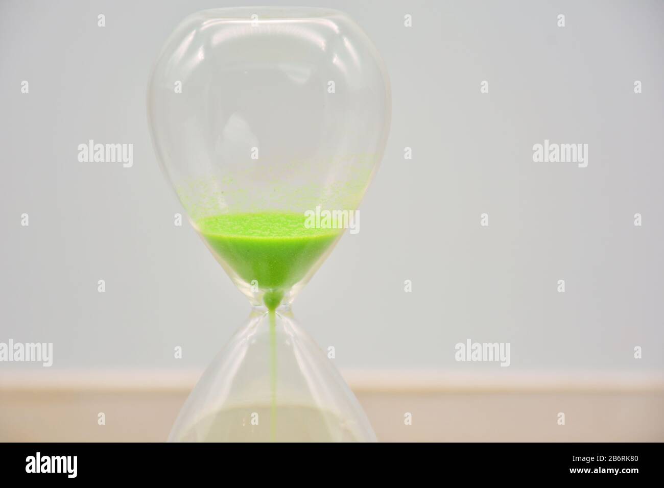 Hourglass, with green sand, arranged in different ways Stock Photo