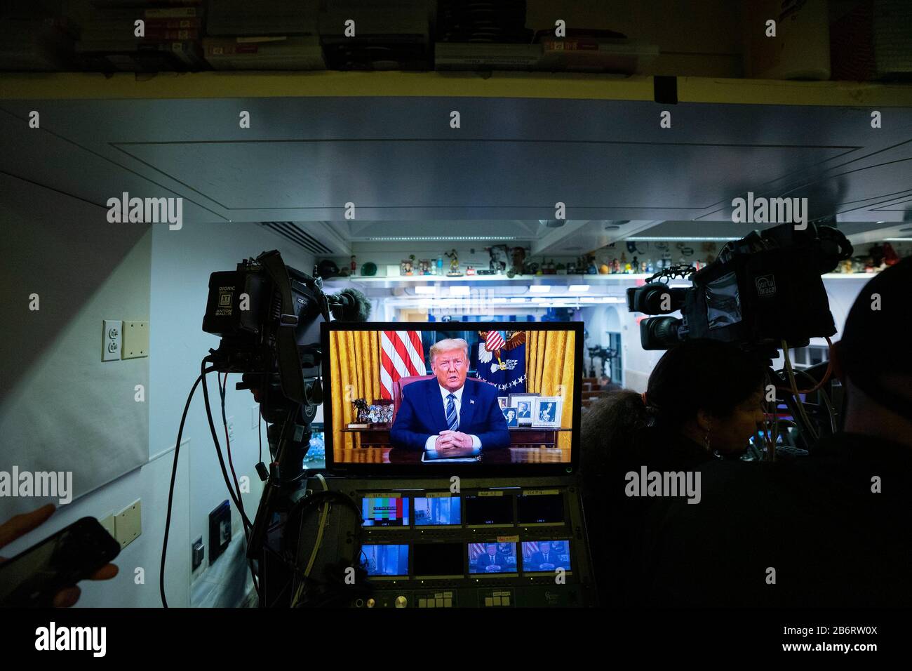 A monitor is seen in the James S. Brady Press Briefing Room of the White House in Washington, DC, U.S., on Wednesday, March 11, 2020 as United States President Donald J. Trump addresses the nation from the Oval Office. Trump announced a month long travel ban to Europe, as well as economic aid to businesses in areas affected by the Coronavirus. Credit: Stefani Reynolds/CNP | usage worldwide Stock Photo