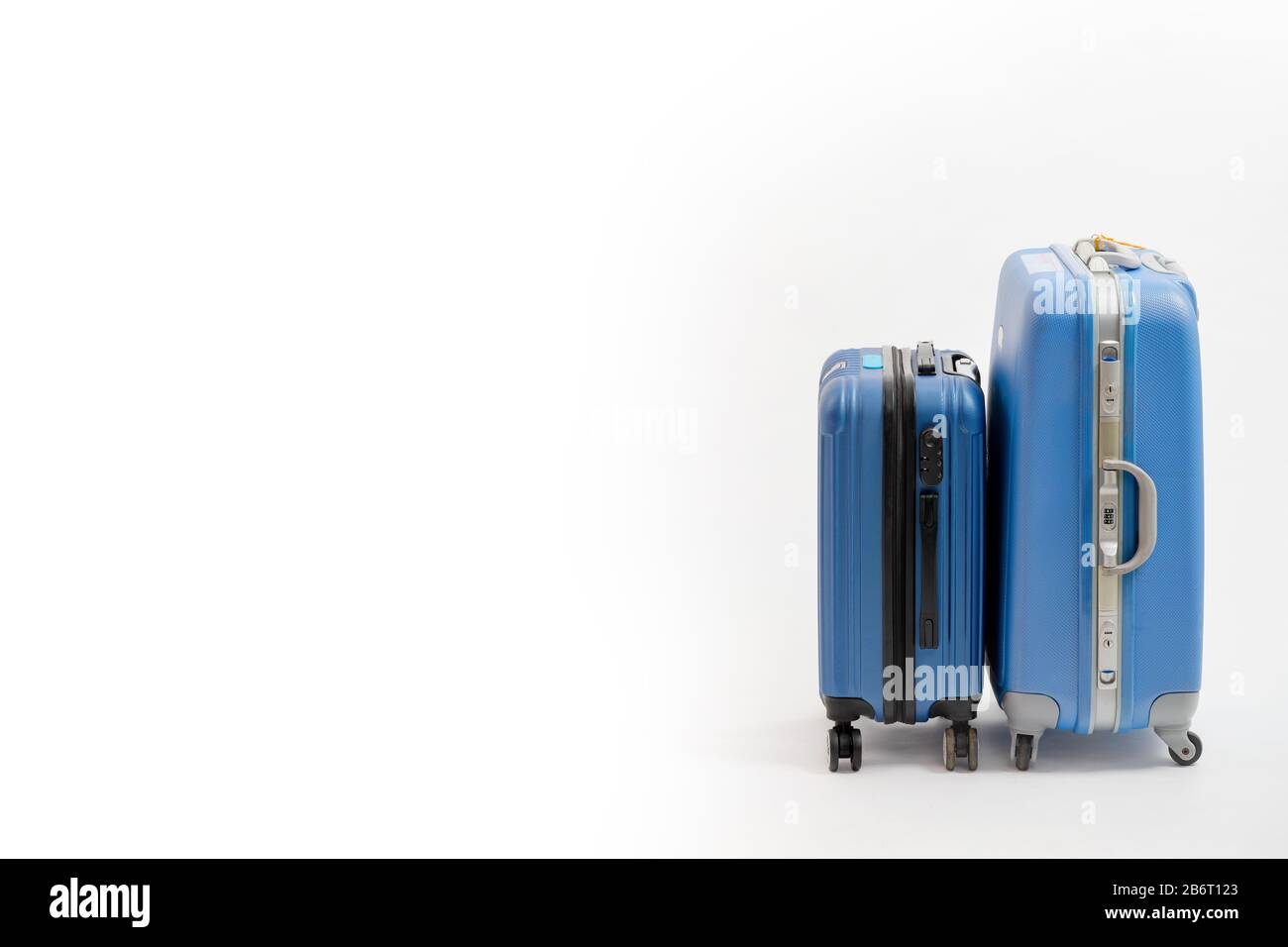 Two blue suitcase isolated on white background. Blue suitcase. Stock Photo