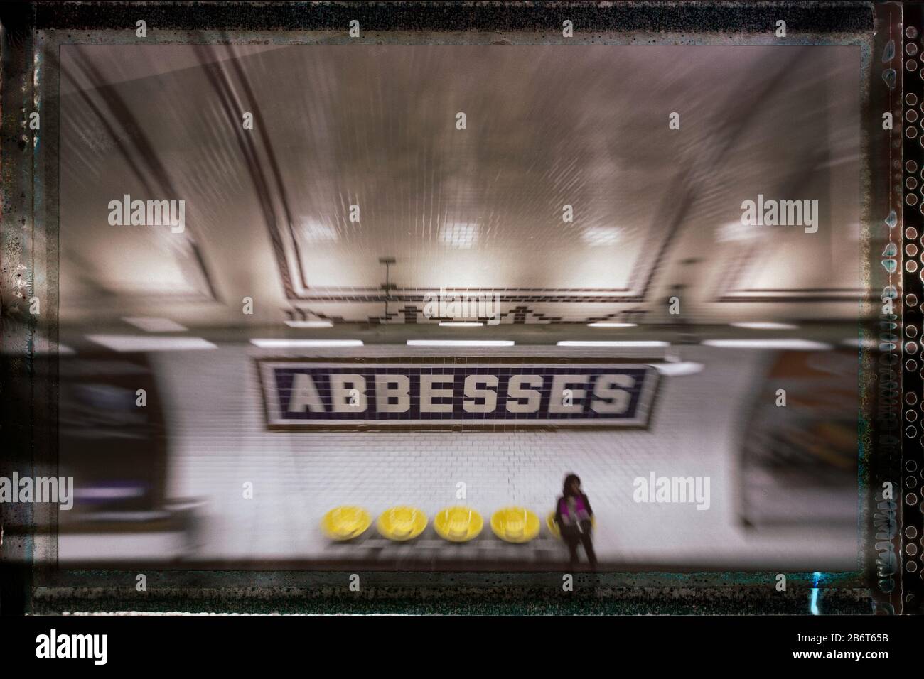Woman waiting on a train alone on the platform at Abbesses Metro station, Montmartre, Right Bank, Paris, France, Europe, color Stock Photo