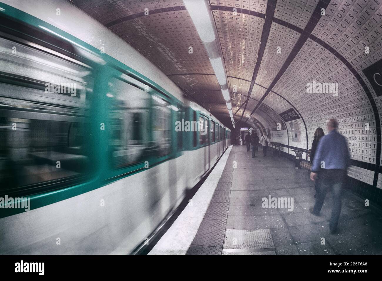 People walking toward the exit after leaving the train at Concorde Metro station, Right Bank, Paris France, Europe, color Stock Photo