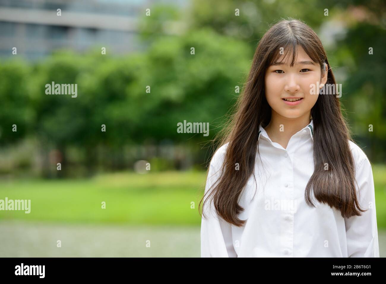 Happy young beautiful Asian teenage girl at the park Stock Photo - Alamy