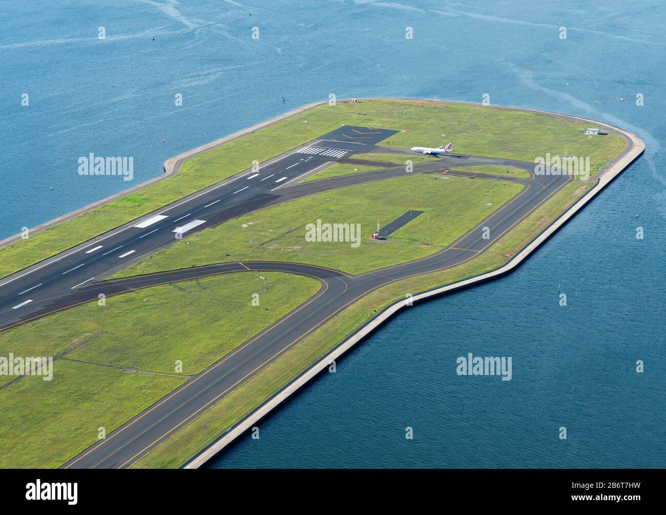 Airport runway built in reclaimed land at Sydney Kingsford Smith International Airport (SYD / YSSY), NSW, Australia. Aircraft taxiing. Stock Photo