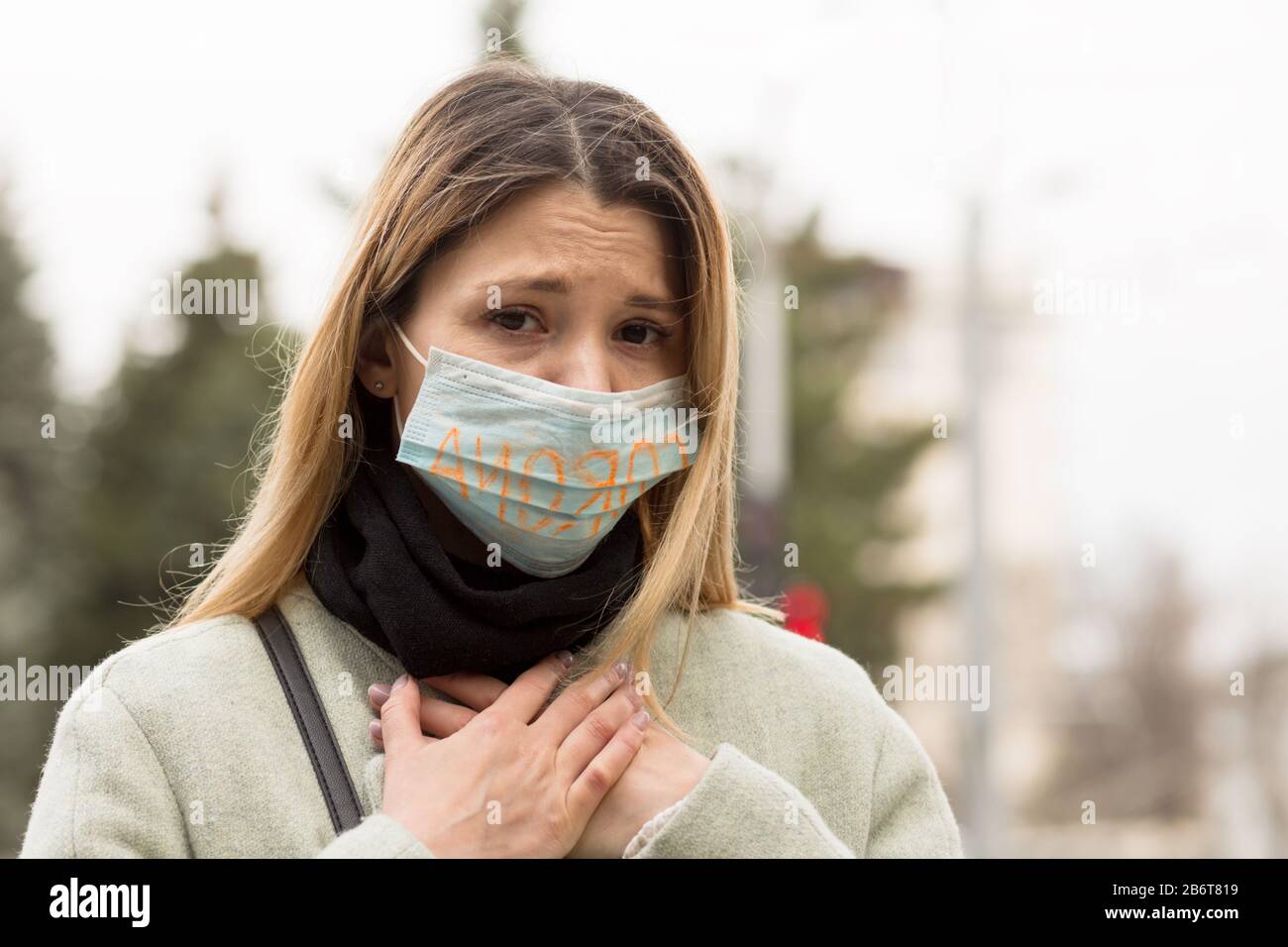 Girl with mask to protect her from Corona virus. Corona written on mask. Woman with mask