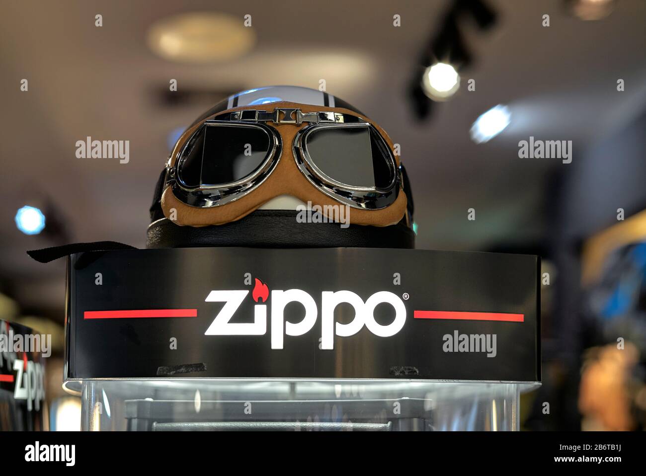 Zippo lighter promotion stand featuring vintage motorcycle helmet and  goggles. The lighters are popular with bikers Stock Photo - Alamy
