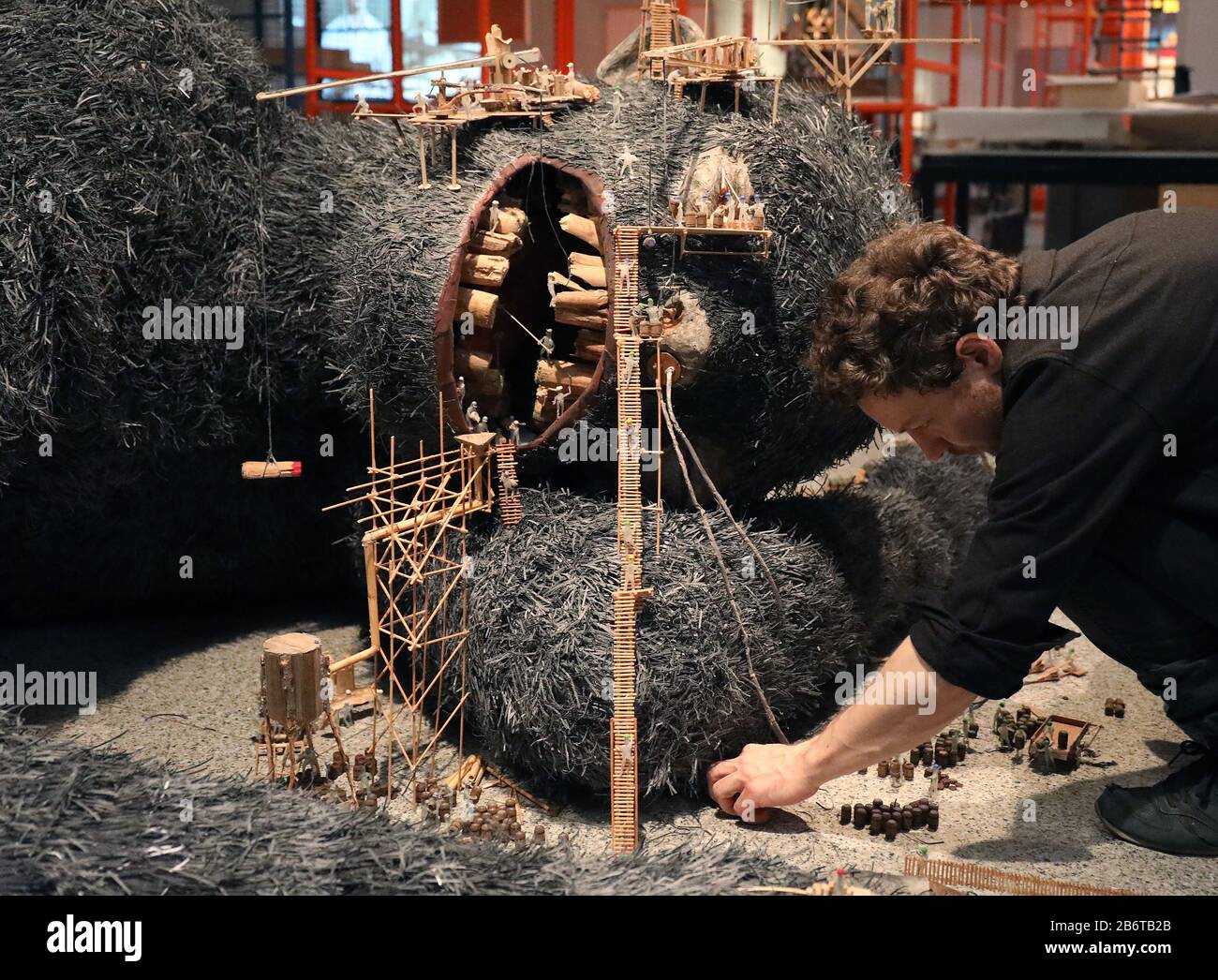 Bonn, Germany. 11th Mar, 2020. The artist Matthias Böhler builds up his work 'Give us, dear'. The exhibition 'Wir Kapitalisten - Von Anfang bis Turbo' can be seen from March 13 to July 12, 2020 in the Bundeskunsthalle. Credit: Oliver Berg/dpa - ATTENTION: For editorial use only in connection with reporting on the exhibition/dpa/Alamy Live News Stock Photo