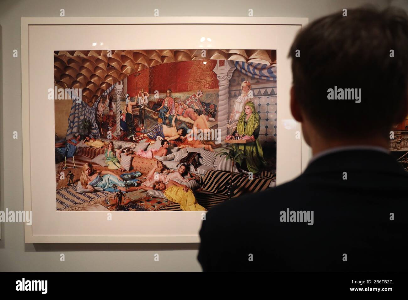 Bonn, Germany. 11th Mar, 2020. A man looks at a photograph by Daniela Rossel from the series 'Ricas y Famoses' (Rice and Famous). The exhibition 'Wir Kapitalisten - Von Anfang bis Turbo' can be seen from 13 March to 12 July 2020 in the Bundeskunsthalle. Credit: Oliver Berg/dpa - ATTENTION: For editorial use only in connection with reporting on the exhibition/dpa/Alamy Live News Stock Photo