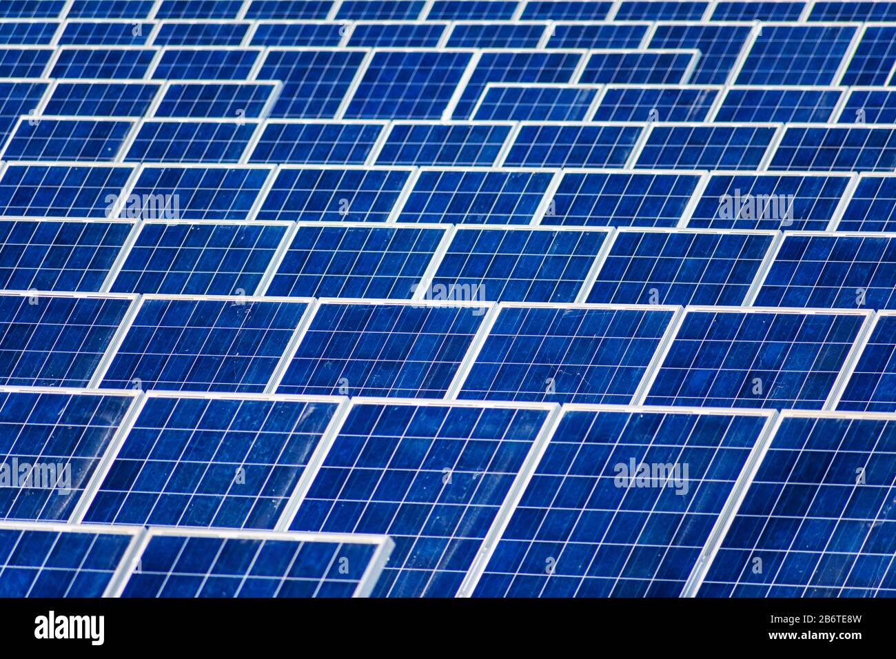 Dusty solar panels surface requires maintenance and cleaning. Solar power electric generating system and facility. Stock Photo