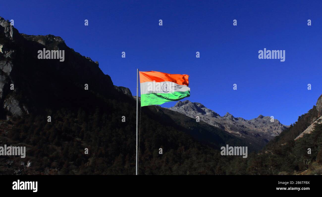 indian national flag flying in the sky near indo-china border in tawang district, arunachal pradesh, north east india Stock Photo