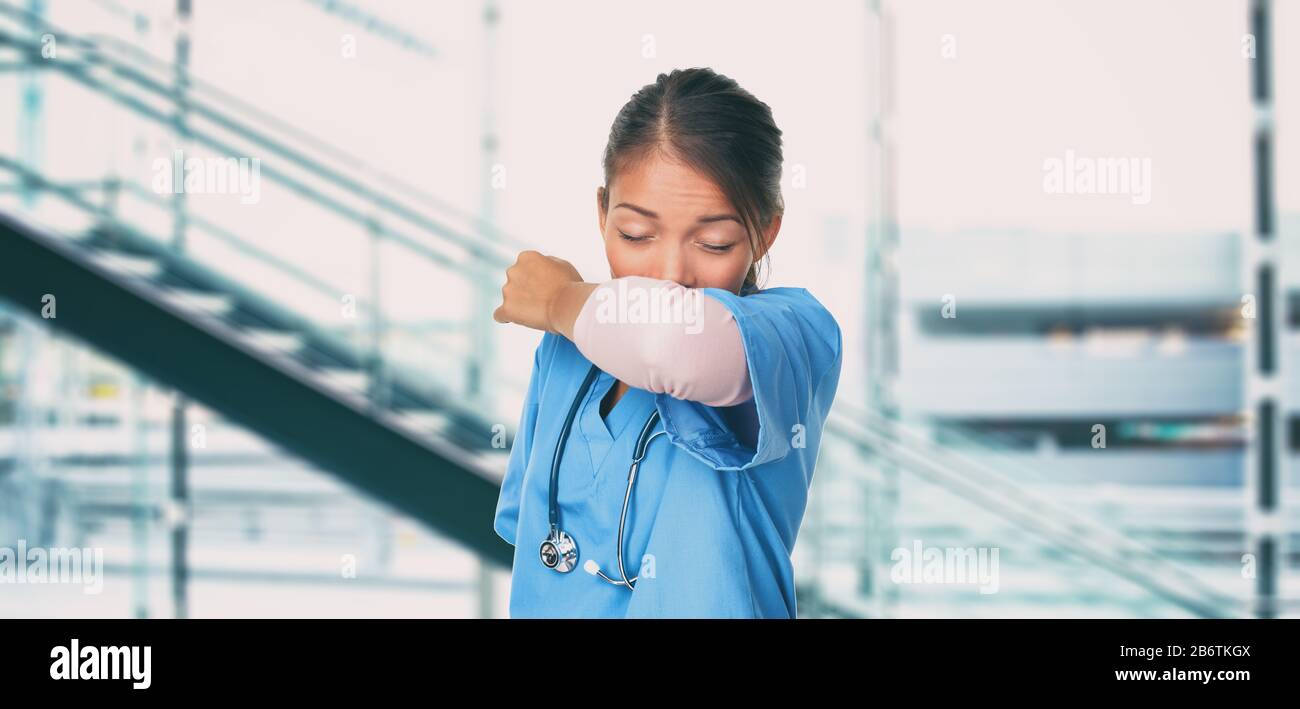 Novel Coronavirus 2019-nCoV Wuhan chinese hospital nurse or Asian doctor woman worker sneezing into arm covering mouth and nose while coughing flu. Virus protection prevention panoramic banner. Stock Photo
