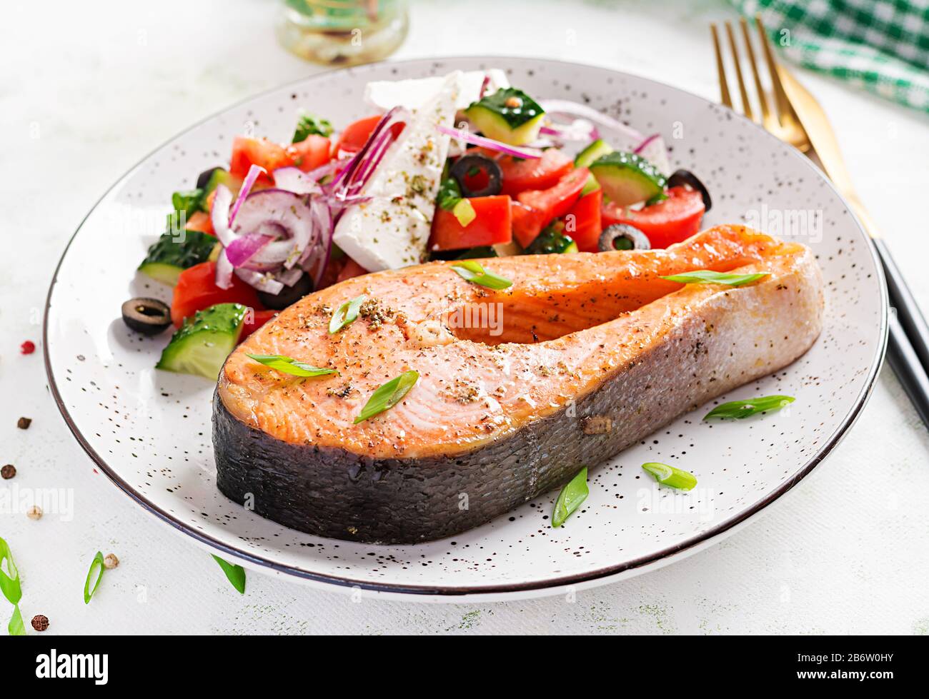 Ketogenic lunch. Baked salmon garnished with greek salad. Healthy