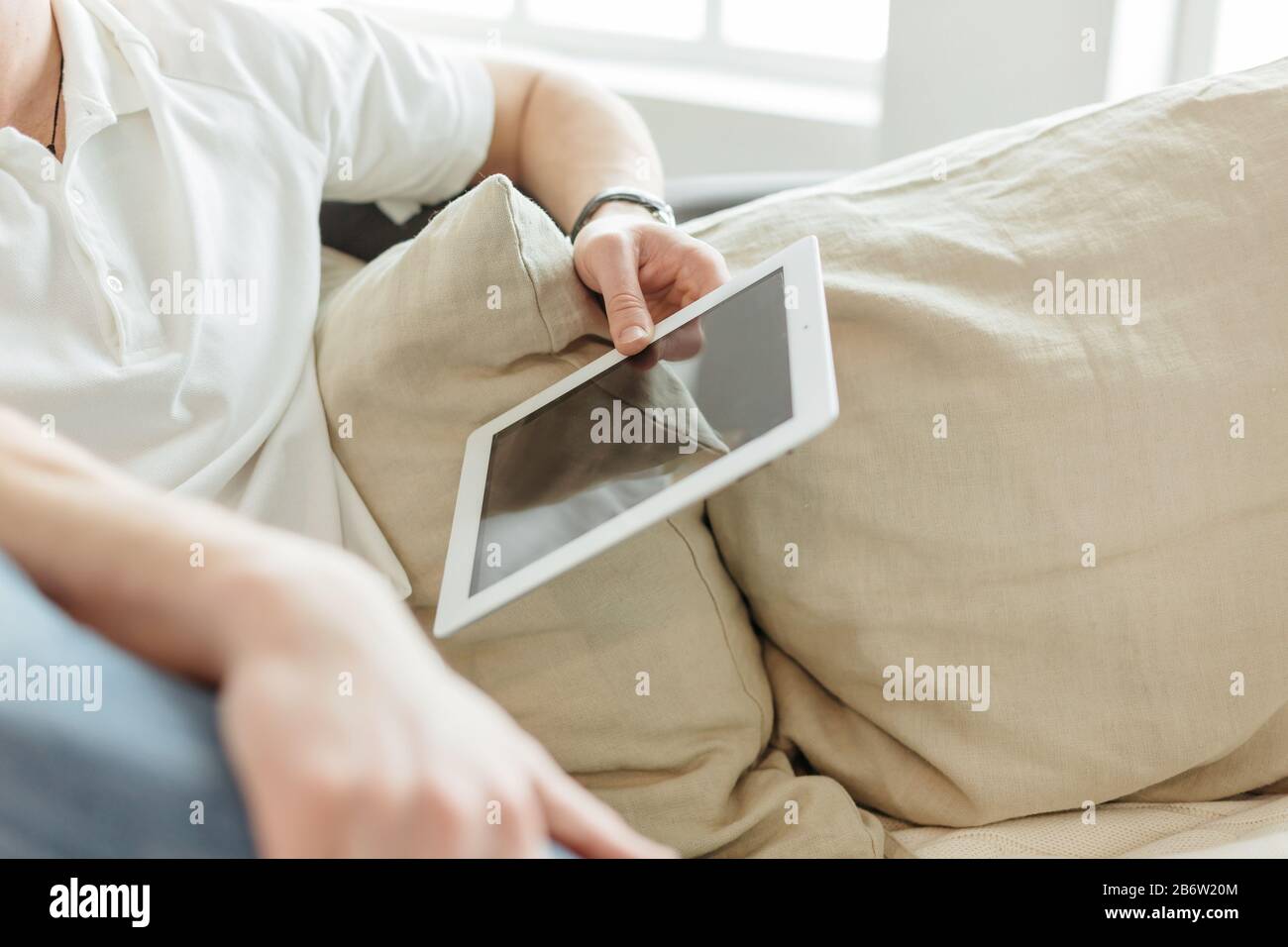 young man reading mail on a digital tablet Stock Photo